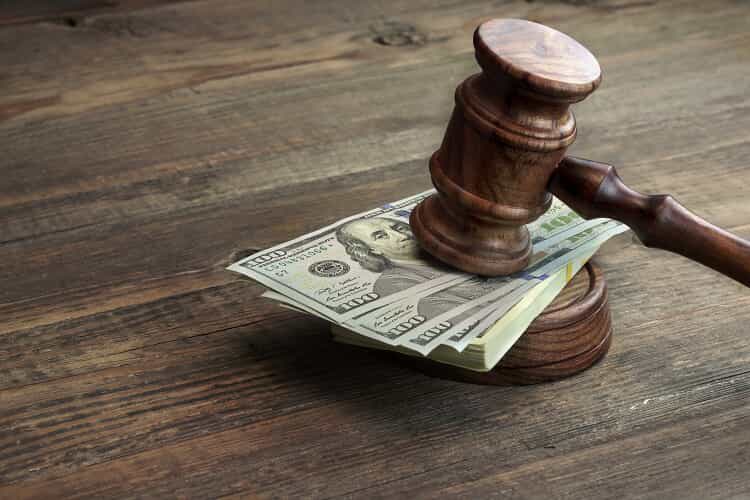 A Gavel Hitting a Stack of Money