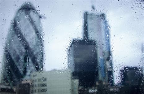 Raindrops on a window obscuring the London financial district skyline