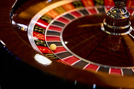 Roulette ball resting in a pocket of a casino roulette wheel