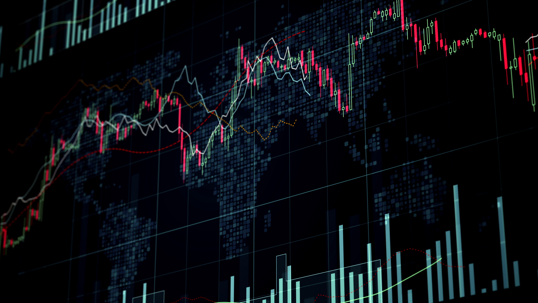 Financial market trading screen showing candlestick charts and volume data overlaid on a global map
